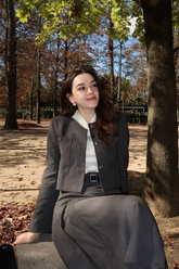 a lady wears a cropped jacket with a midi skirt